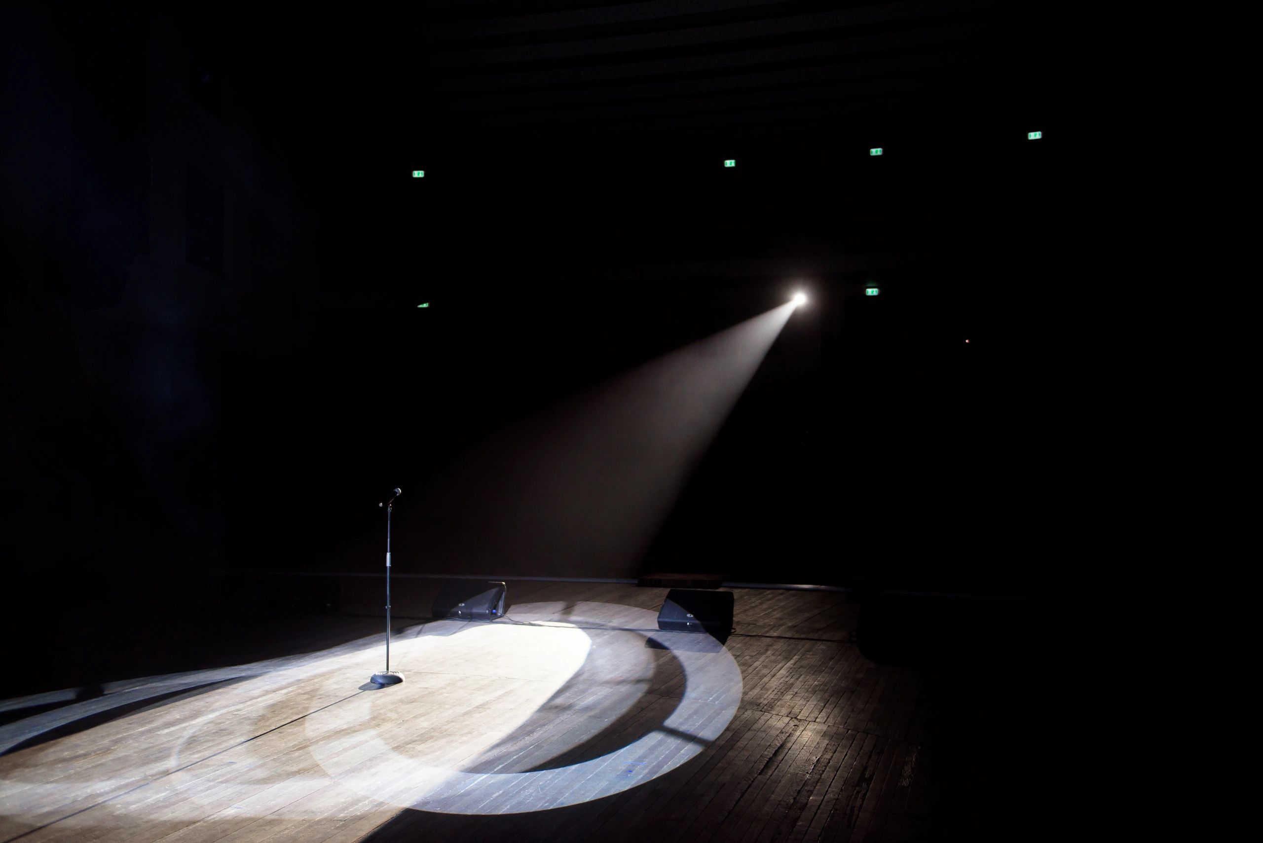 Microphone under a spotlight on a dark stage