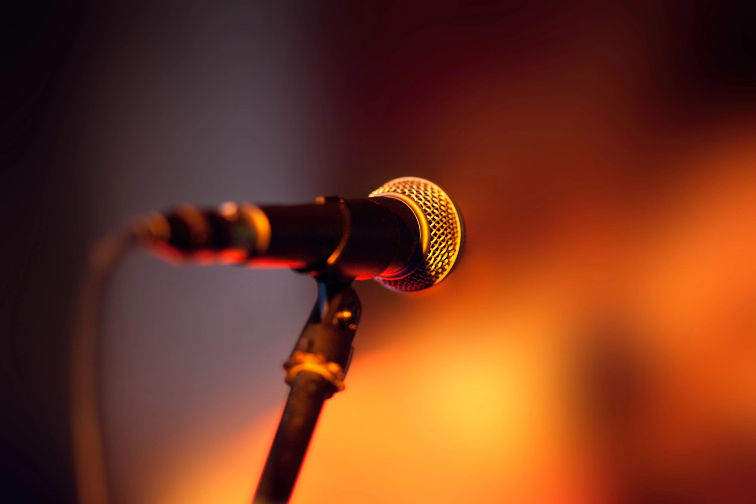 Close-up of a microphone on a stage under lights