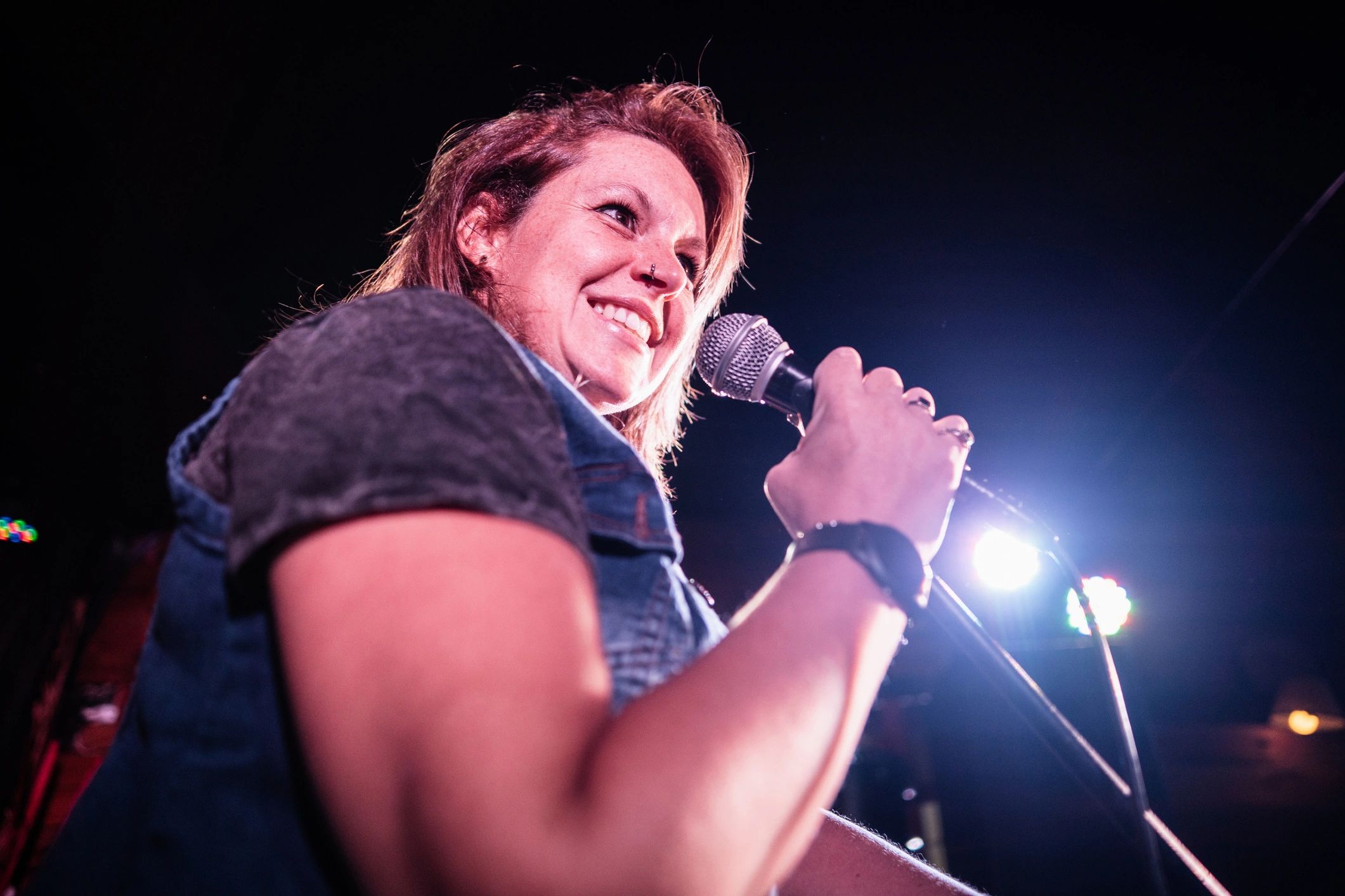 Performer on stage under club lighting