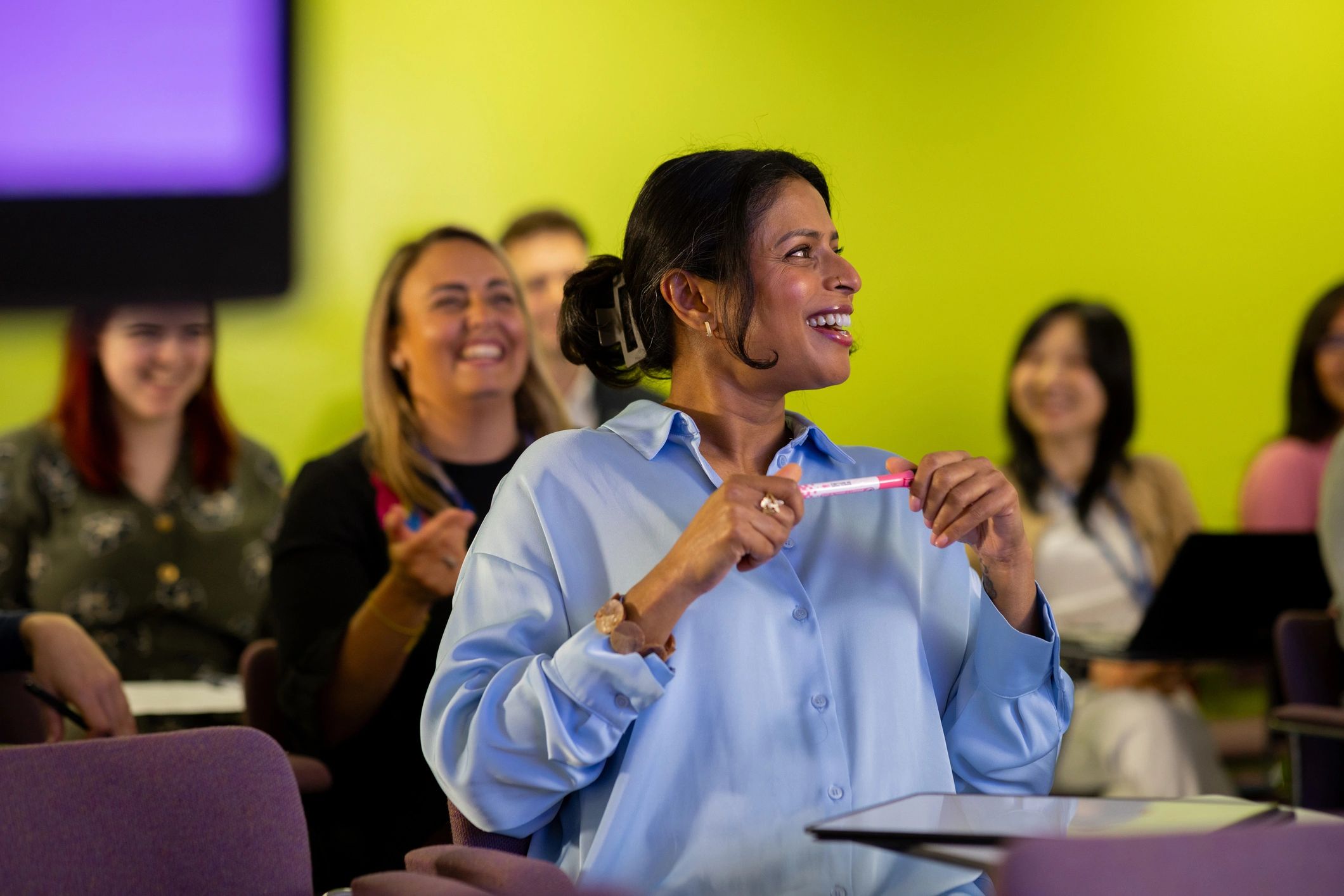 Attendees laughing during a live talk
